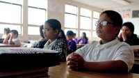 Students at their desks taking a quiet moment