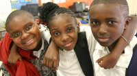 Three students smiling