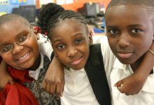 Three students smiling