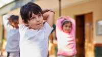 Elementary students doing stretches between lessons in class