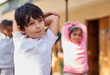 Elementary students doing stretches between lessons in class