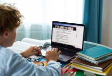 Teenage boy at desk attending online class. 