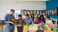 Photo of middle school teacher and students in science class