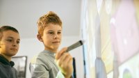 Photo of elementary student with whiteboard