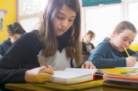 Middle school students writing in math class