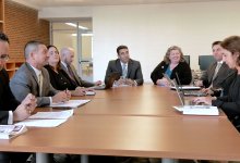 photograph of people around a conference room table