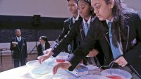 photo of students at a table with bowls on top of it