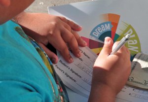 Boy filling out his deposit slip