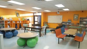 A classroom filled with tables of various shapes and a range of different seating.