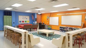 A classroom filled with pew and booth seating