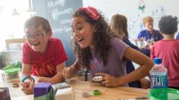 Students looking excited to do a science experiment in a school science lab