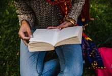 A teenage girl reads in a park