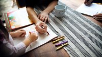 Mother coloring a picture with her daughter